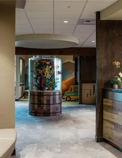 A reception area in a medical office with a fish tank.