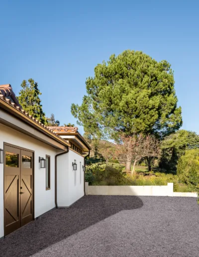 A house with a driveway and trees in the background.